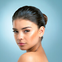 Naklejka premium Blue background, portrait and girl with skincare for glow, natural beauty and self care with pride. Female model, treatment and results for face wellness, cosmetics and confidence of woman by studio