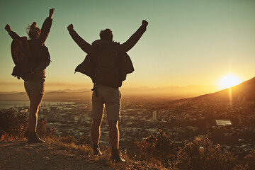 Couple, arms and hiking celebration on mountain for winning, sports goals and fitness in nature. Man, woman and achievement or happy on hill for trekking success, training and summit peak in Mexico