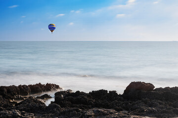 Ostuni, crenellated coast with a hot air balloon in the distance.