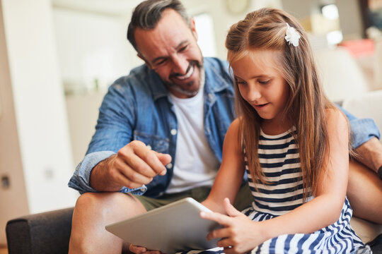 Girl, father and tablet for support, helping and online educational games, e learning or teaching at home. Excited man, dad and child or family reading on digital app for parental safety and security - Powered by Adobe