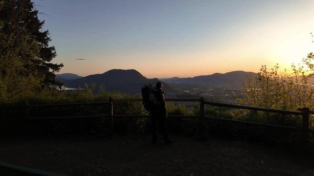 Father and son at viewpoint at summit on trail in Chilliwack. Sunset, spring season. Trees, lookout. British Columbia, Canada.