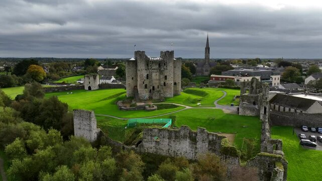 Trim Castle, County Meath, Ireland, October 2023. Drone clockwise orbit pushing into a close angle of the Norman Fortress on the banks of the Boyne River surrounded by the imposing Curtain Walls.