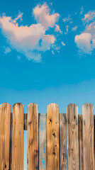 Wooden fence against blue sky background