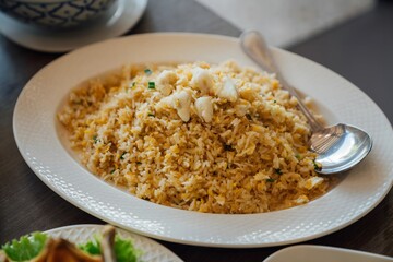 Schezwan Fried Rice Masala is a popular indo-chinese food served in a plate or bowl with chopsticks. selective focus