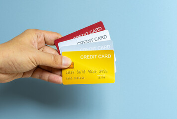 Man holdin credit cards and he is choosing a credit card to pay and spend Payment for goods via credit card. Finance and banking concept	