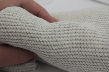 hand holding a knitted object