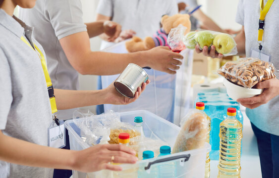Food bank distribution table, volunteer group working in charitable foundation, make donation to needy. Charity, separating stuff, basic need provisions, free nutrition assistance to low-income people