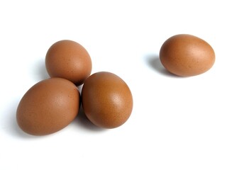 Brown chicken eggs isolated against white background