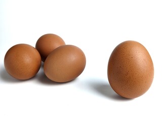 Brown chicken eggs isolated against white background