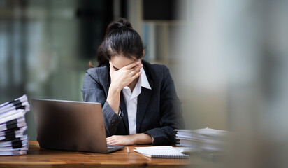 Tired asian businesswoman with headache at office, feeling sick at work, copy space