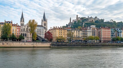 Fototapeta premium In Lyon, France, on October 6, 2019, the view includes the Church of St. George situated alongside buildings lining the Saone River at Quai Fulchiron in the Old City's 5th arrondissement.