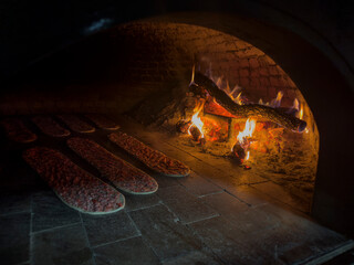 Baking meat bread, the trademark dish of the Konya region in Turkey, in the oven