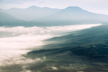 A fantastic view of the peaks of the mountain range above the clouds. Crimea, Ukraine