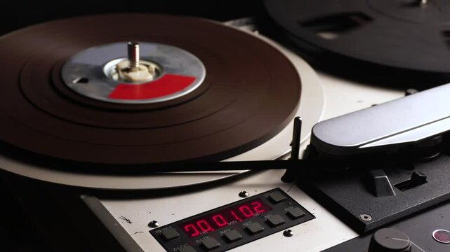 Reel to Reel Audio Tape Rolling During Playback or Recording in Professional Magnetophone, Close Up