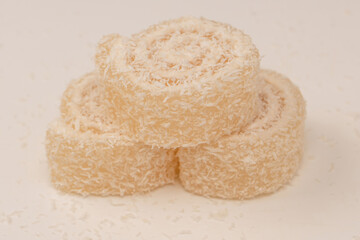 Coconut candy roll isolated on a white background.