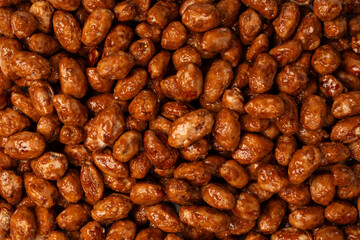 Tasty sweet roasted peanuts as a background.