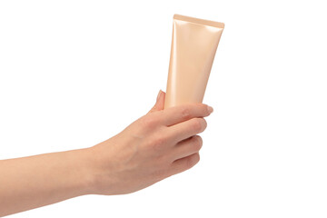 Beige cream tube in woman hands isolated on a white background.