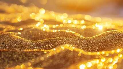 Glittering gold sand grains. Golden reflection of the sunset in the sand on the beach. Shiny background