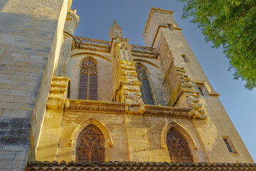 Cathedral Saint-Nazaire-A river runs through a town with a castle in the background