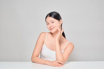 Asian female model lightly touching her skin. Korean cosmetics model.
