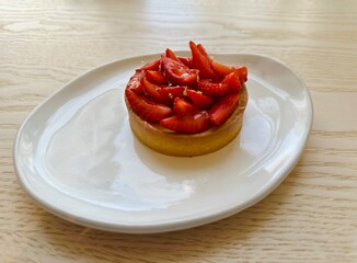 Strawberry cake on a white plate. sweet basket with cream and strawberries, 
