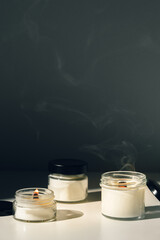 Scented Candles Burning On White Surface With Black Background