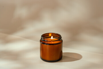 Candles in Glass Jars on a Light Beige Surface
