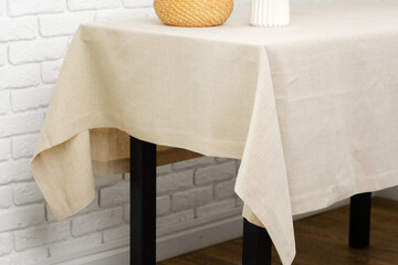 White Brick Wall With Beige Tablecloth and Basket