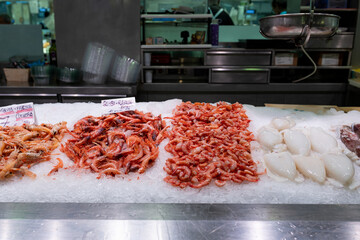 Calamari, Tasty yummy Fresh organic shrimps or prawns with price on ice background. Fish market