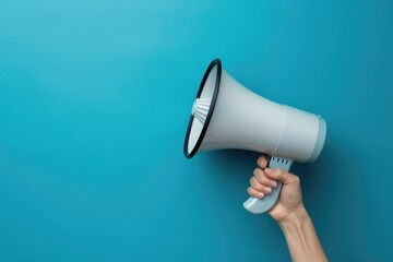 Hand holding a megaphone on blue background