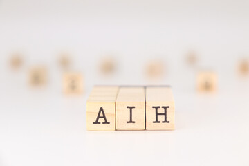 AIH abbreviation- Concept of Artificial Intelligence Hype written on wooden cubes isolated on white background with copy space for text phrase

