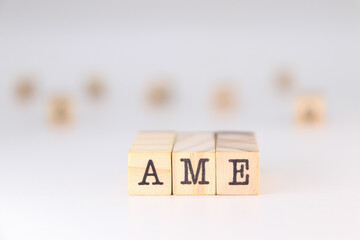 AME Acronym - Concept of Additive Manufacturing Equipment written on wooden cubes isolated on white background with copy space for the text 