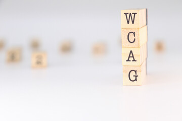 WCAG acronym - Concept of Web Content Accessibility Guidelines written on wooden cubes isolated on white background with copy space for text phrase.