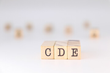 CDE acronym - Concept of Collaborative Data Exchange written on wooden cubes isolated on white background with copy space for text.