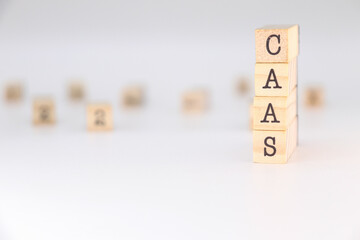 CaaS acronym - Concept of Containers as a Service written on wooden blocks isolated on white background with copy space for text.