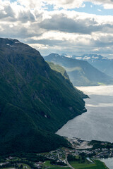 Fototapeta premium view from above over Andalsnes in Rauma in Norway on fjord valley on a sunny summer day with mountains in the background