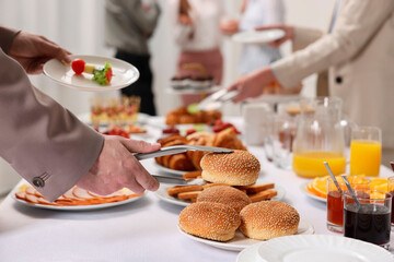 Coworkers having business lunch in restaurant, closeup