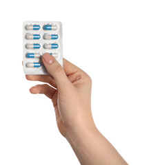 Fototapeta premium Woman with antibiotic pills on white background, closeup