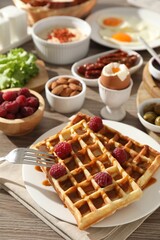 Different meals served for breakfast on wooden table