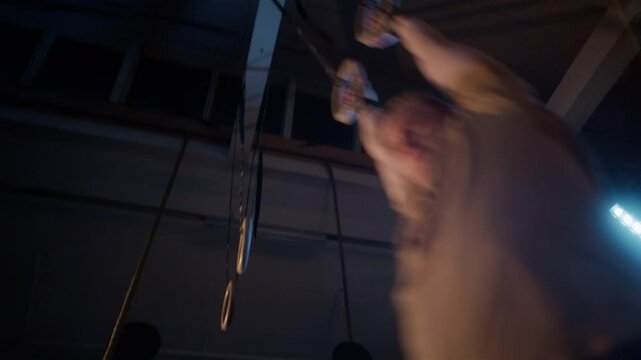CrossFitter Doing Ring Muscle Ups From A Low-Angle View