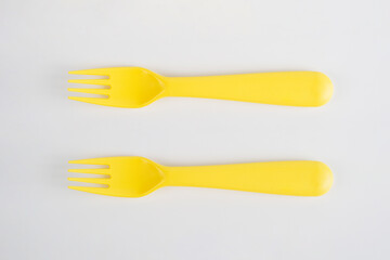 Yellow fork and spoon isolated on white background.