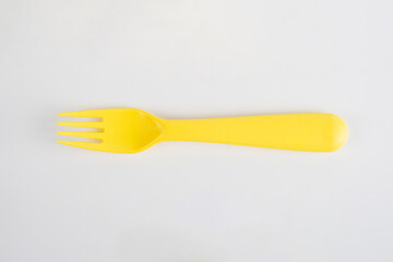Yellow fork and spoon isolated on white background.