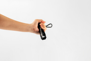 Electric LED torch flashlight in hand isolated on a white background