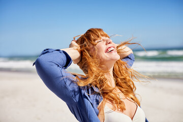 Happy young woman enjoying sun at summer beach