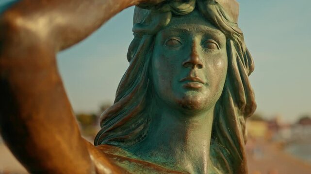 Statue of siren looking at the sea located in Ustka in Poland