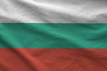 Bulgaria flag depicted on folded wavy fabric of old cloth close up
