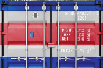 Costa Rica flag depicted on metal doors of shipping cargo container outdoors in docks area close up