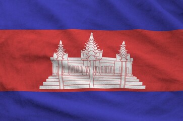 Cambodia flag depicted on folded wavy fabric of old cloth close up