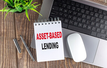 ASSET-BASED LENDING text on a notebook with laptop, mouse and pen .