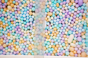 Multi-colored foam balls in a transparent box. background and texture. Original gift wrapping.